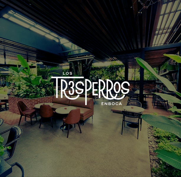 Interior de Los Tres Perros con el logo superpuesto
